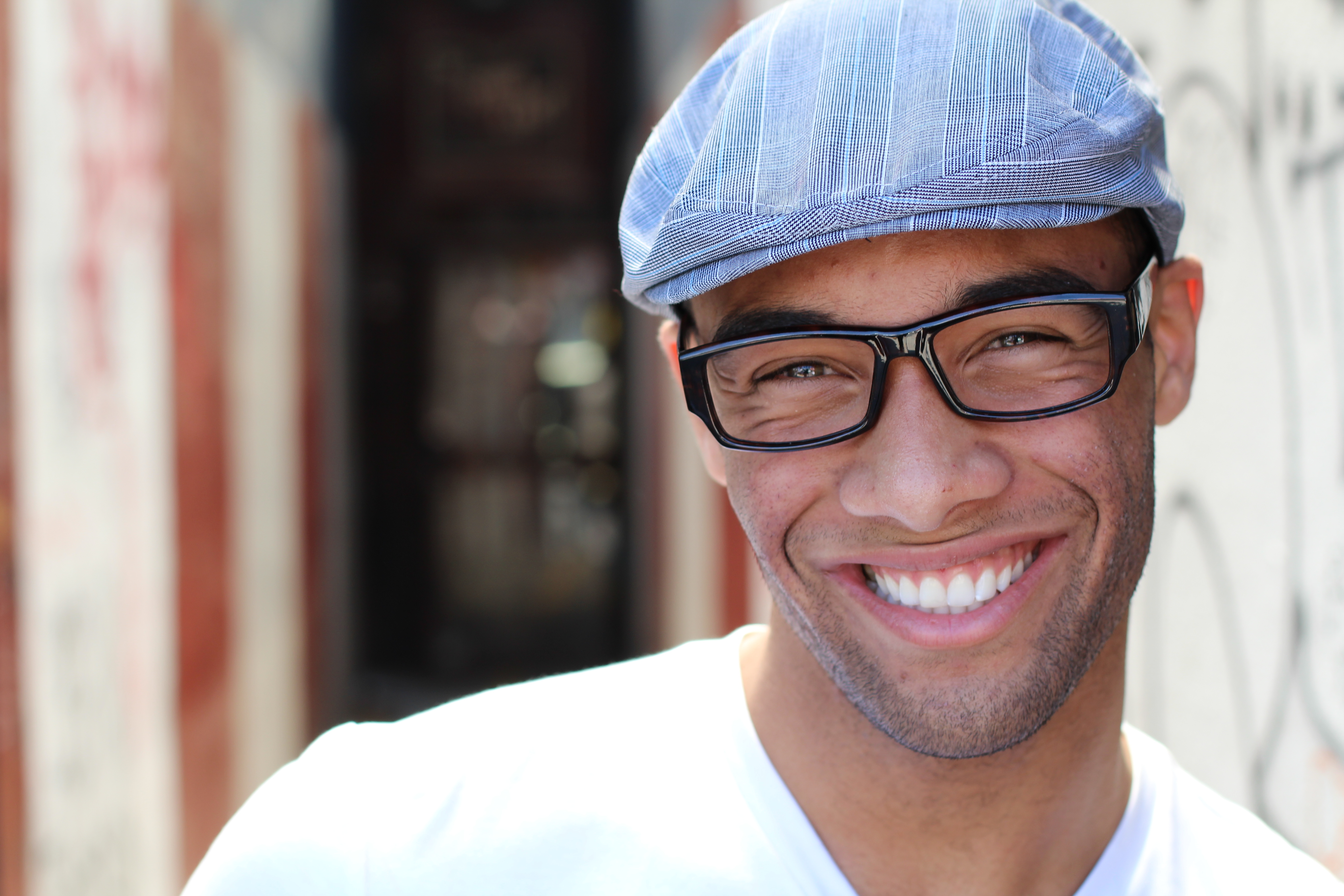 Healthy Smile. Teeth Whitening. Beautiful Smiling Young man Portrait close up. Over modern corridor background . Laughing businessman with Perfect Shin. Copy space for text.